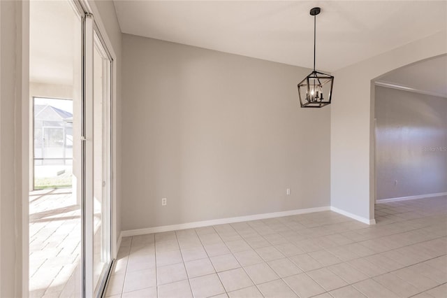 unfurnished dining area with light tile patterned floors and an inviting chandelier