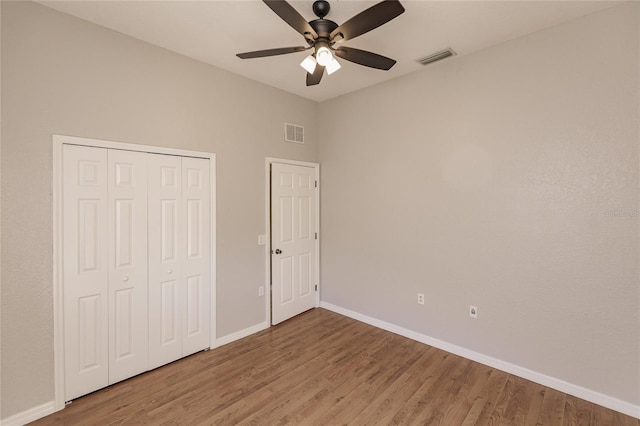 unfurnished bedroom with a closet, ceiling fan, and hardwood / wood-style floors