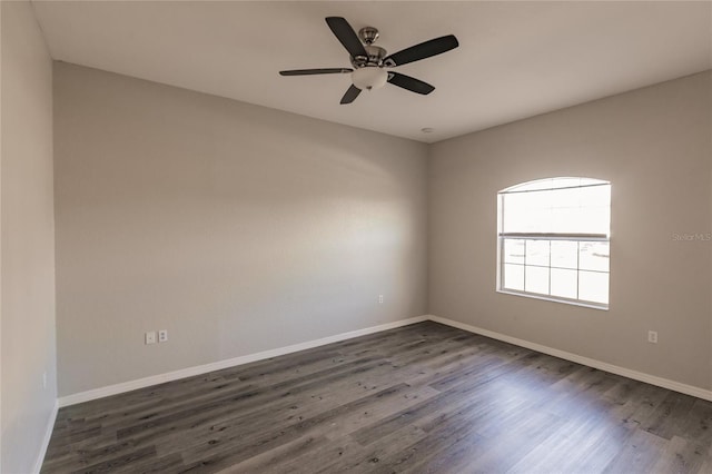 empty room with dark hardwood / wood-style floors and ceiling fan