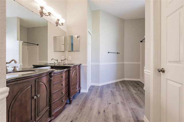 bathroom with hardwood / wood-style floors and vanity