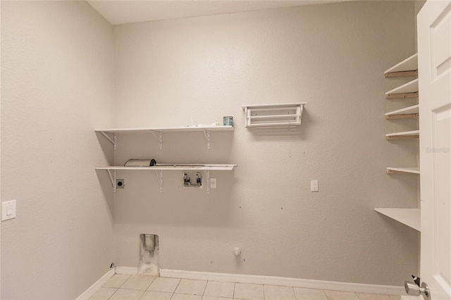 laundry area with washer hookup, electric dryer hookup, hookup for a gas dryer, and light tile patterned floors