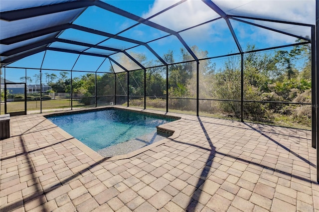 view of swimming pool featuring a patio area and a lanai