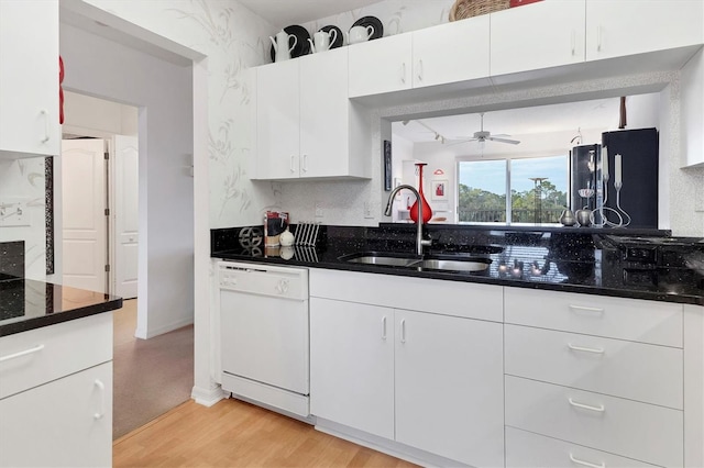 kitchen with sink, dishwasher, and white cabinets