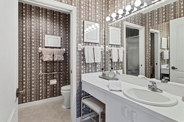 bathroom featuring vanity, toilet, and tile patterned flooring