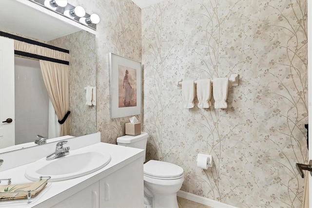 bathroom featuring toilet and vanity