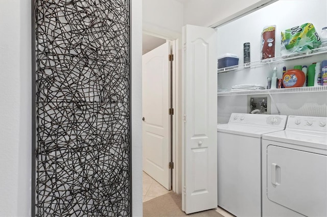 laundry area with washing machine and dryer and light tile patterned flooring