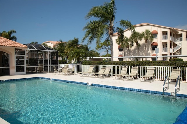 view of swimming pool with a lanai