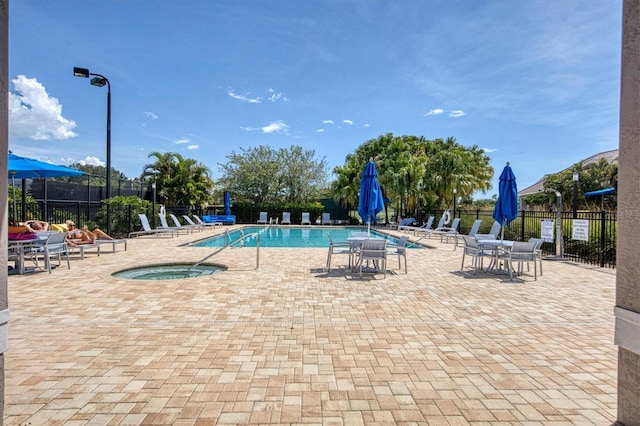 view of pool featuring a patio area and a hot tub