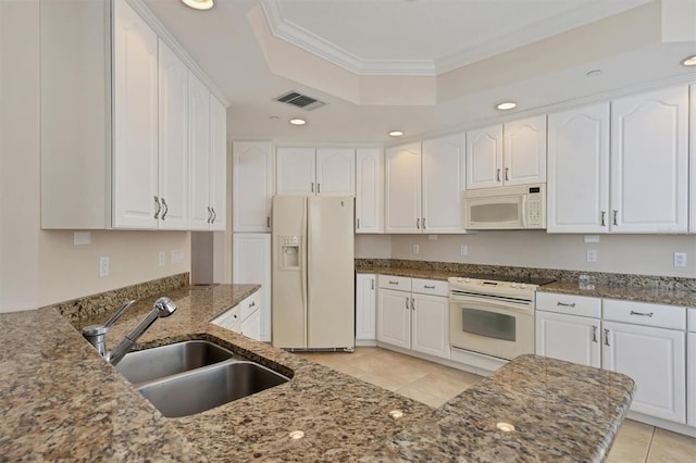 kitchen with sink, white cabinets, and white appliances