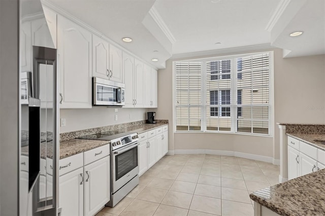 kitchen featuring appliances with stainless steel finishes, crown molding, white cabinetry, stone countertops, and recessed lighting