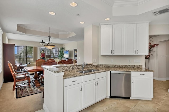 kitchen featuring a tray ceiling, dishwasher, a sink, light stone counters, and crown molding