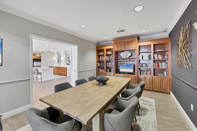 dining space featuring ornamental molding, recessed lighting, baseboards, and light wood-style flooring