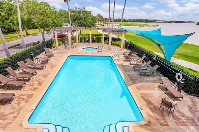 community pool with a pergola, fence, a hot tub, and a patio