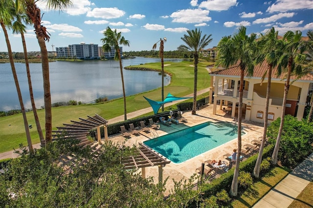 community pool with a patio area, a water view, view of golf course, and a lawn