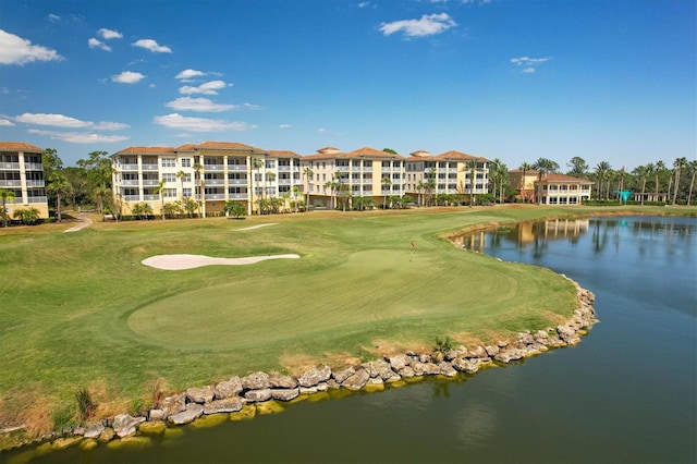 view of property's community featuring view of golf course and a water view