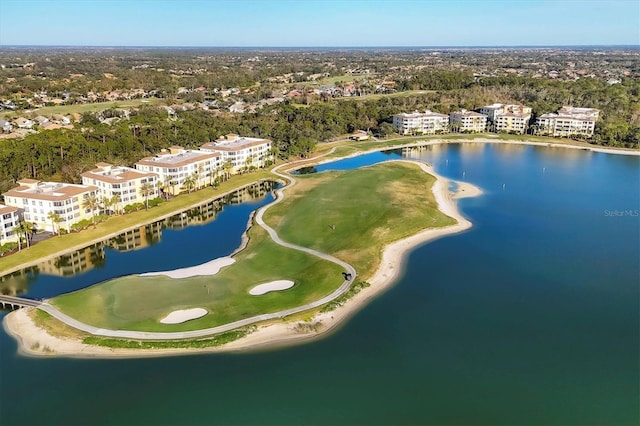 drone / aerial view of a golf club, a large body of water, and a tree filled landscape