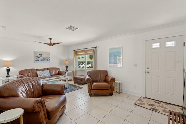 living room with light tile patterned floors, ceiling fan, and ornamental molding