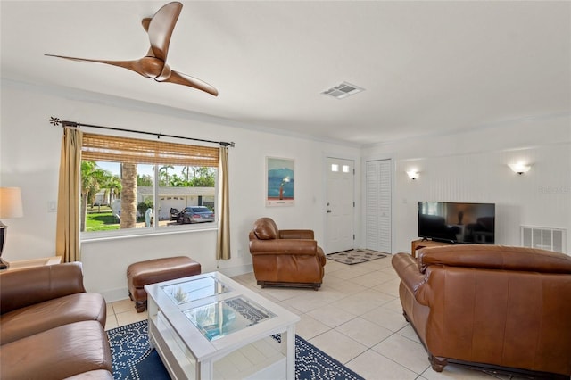 living room featuring light tile patterned floors, ceiling fan, and ornamental molding