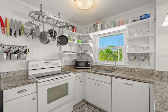 kitchen featuring stone counters, white cabinetry, sink, and white appliances