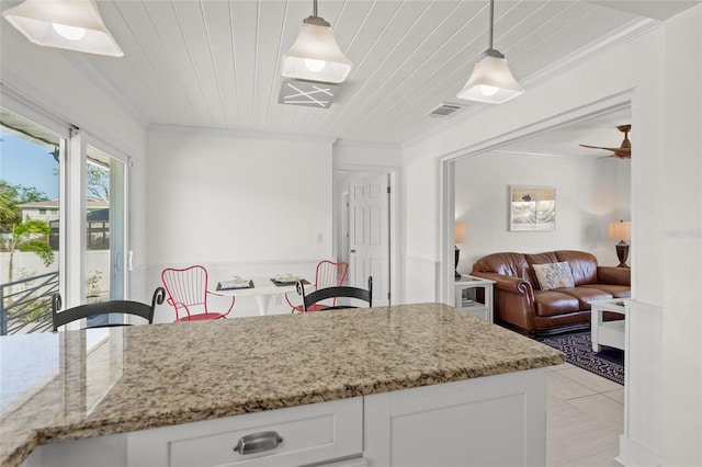 kitchen featuring crown molding, white cabinetry, hanging light fixtures, and wooden ceiling