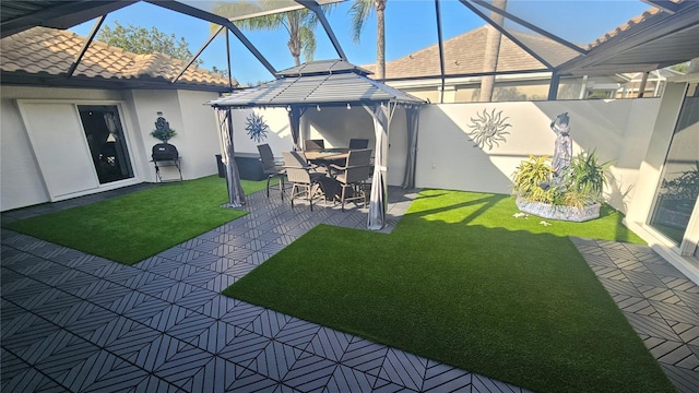 view of yard with glass enclosure, a patio, a gazebo, and fence