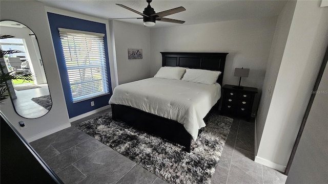 tiled bedroom featuring ceiling fan