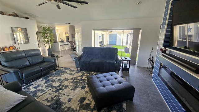 living room featuring ceiling fan and vaulted ceiling