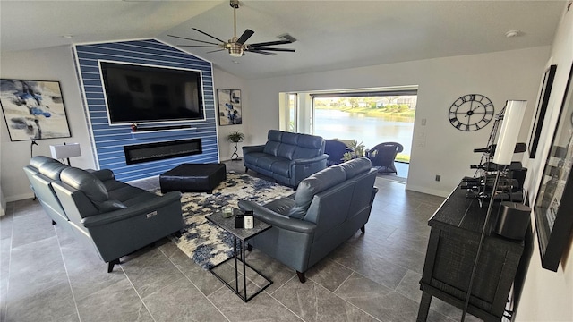 living room featuring ceiling fan, vaulted ceiling, a fireplace, and baseboards