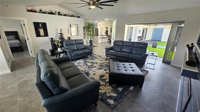 living room featuring ceiling fan and vaulted ceiling