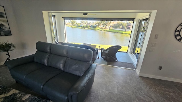 living room with a water view and plenty of natural light