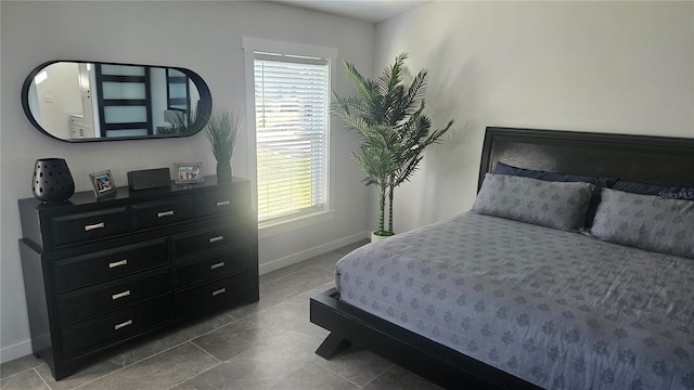 bedroom featuring tile patterned flooring and baseboards