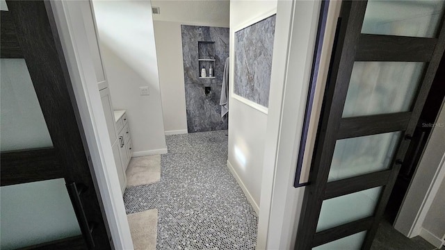 bathroom with vanity and a shower