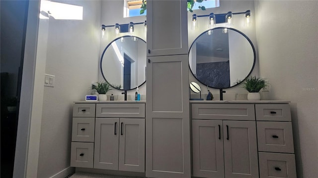 bathroom with vanity and baseboards