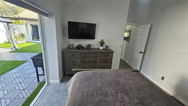 bedroom featuring access to exterior, baseboards, and tile patterned floors