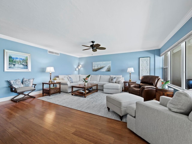 living room featuring hardwood / wood-style flooring, ceiling fan, and crown molding