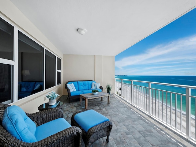 balcony with a water view and a beach view