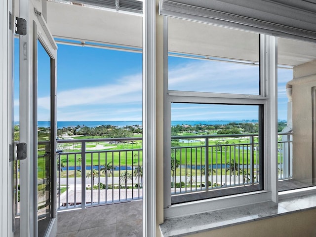 unfurnished sunroom featuring plenty of natural light and a water view