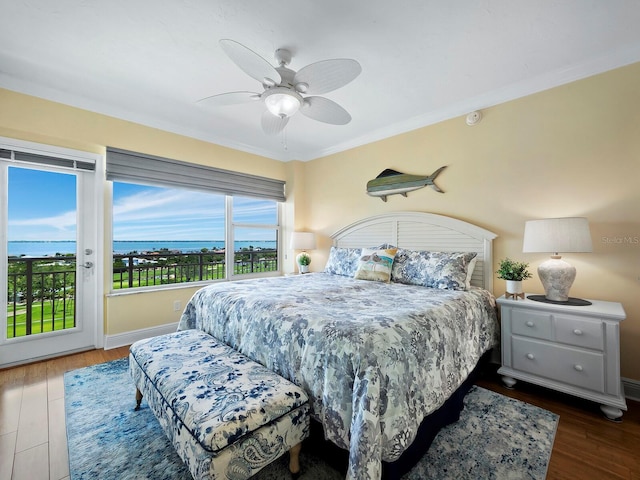 bedroom with ceiling fan, dark hardwood / wood-style flooring, crown molding, access to outside, and a water view