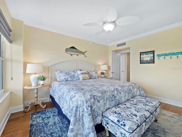 bedroom featuring ceiling fan, dark hardwood / wood-style floors, and ornamental molding