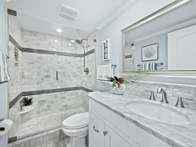 bathroom featuring vanity, a shower with shower door, and toilet