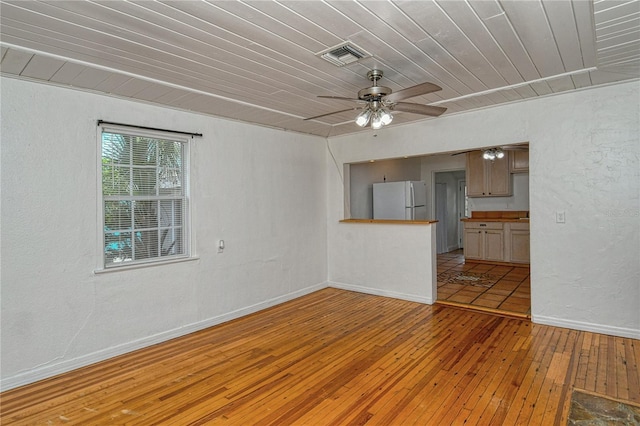 unfurnished living room featuring light hardwood / wood-style floors, ceiling fan, and wood ceiling