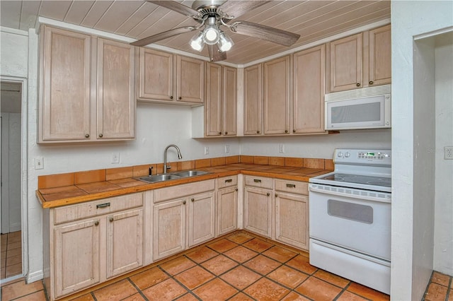 kitchen with tile counters, light brown cabinetry, sink, and white appliances