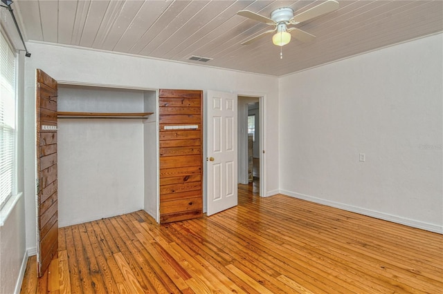 unfurnished bedroom with wooden ceiling, a closet, light hardwood / wood-style flooring, and ceiling fan