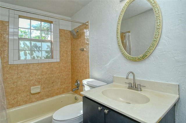 full bathroom with toilet, tiled shower / bath, and vanity