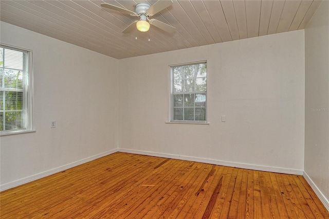 spare room featuring ceiling fan, a wealth of natural light, and light hardwood / wood-style floors