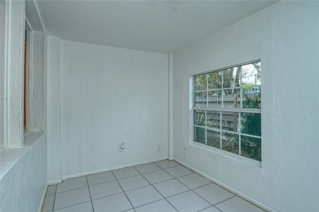 unfurnished room featuring light tile patterned flooring