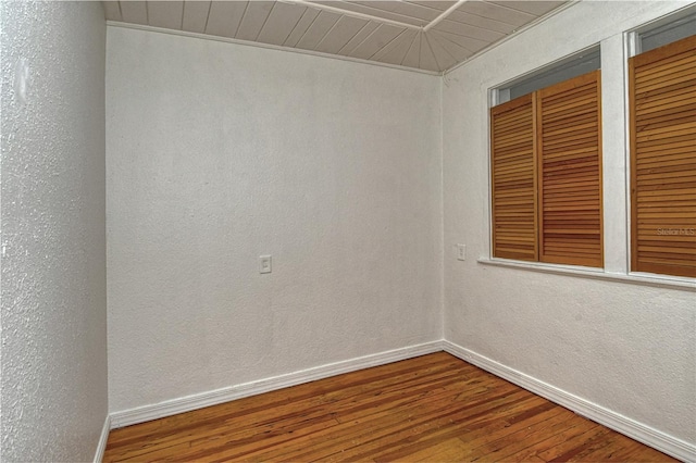 empty room with hardwood / wood-style floors