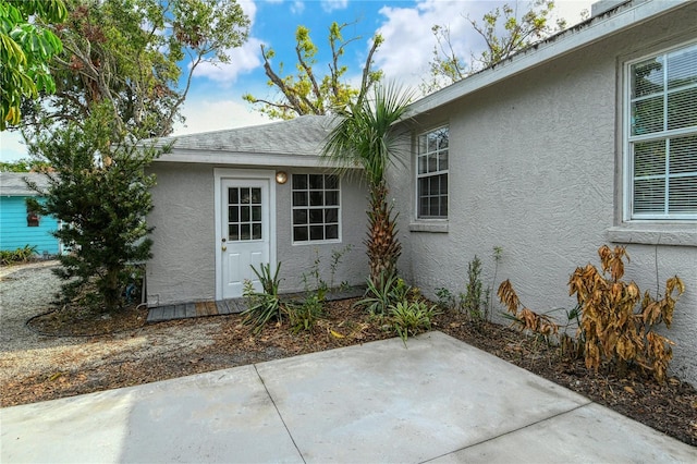 view of side of home with a patio area