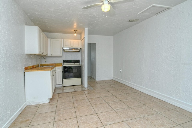 kitchen with white range with electric stovetop, sink, light tile patterned floors, a textured ceiling, and white cabinets