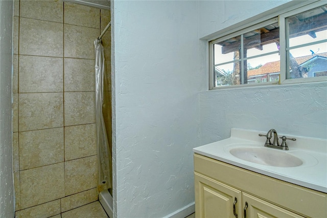 bathroom with curtained shower and vanity